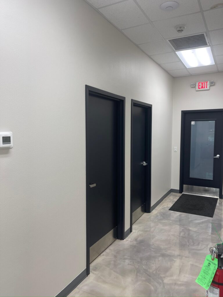 Fort Worth commercial painting - back corridor with charcoal doors leading to an exit