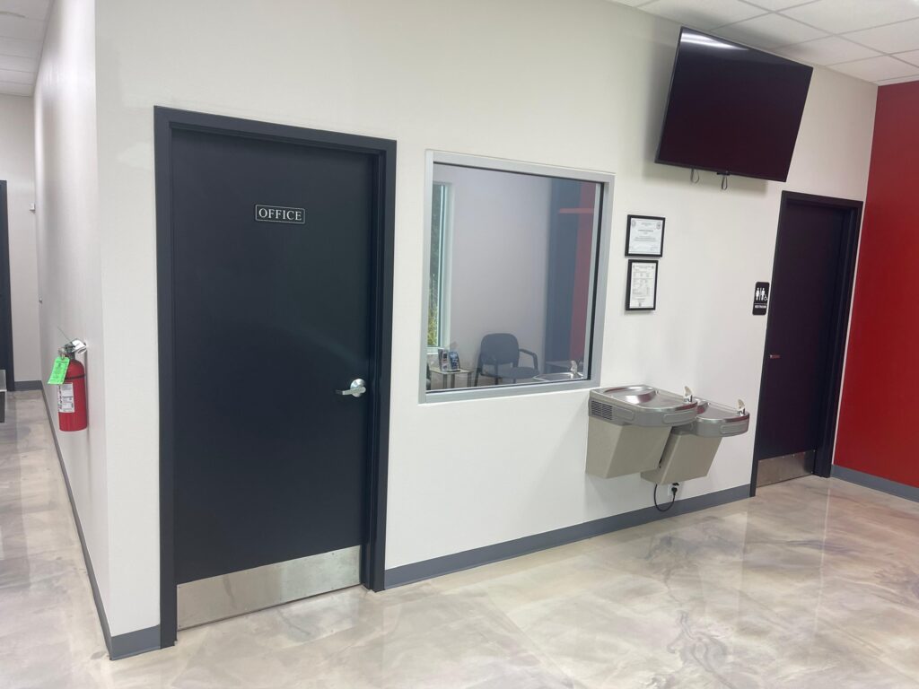Commercial office painting in Fort Worth - corridor with charcoal doors and reception window