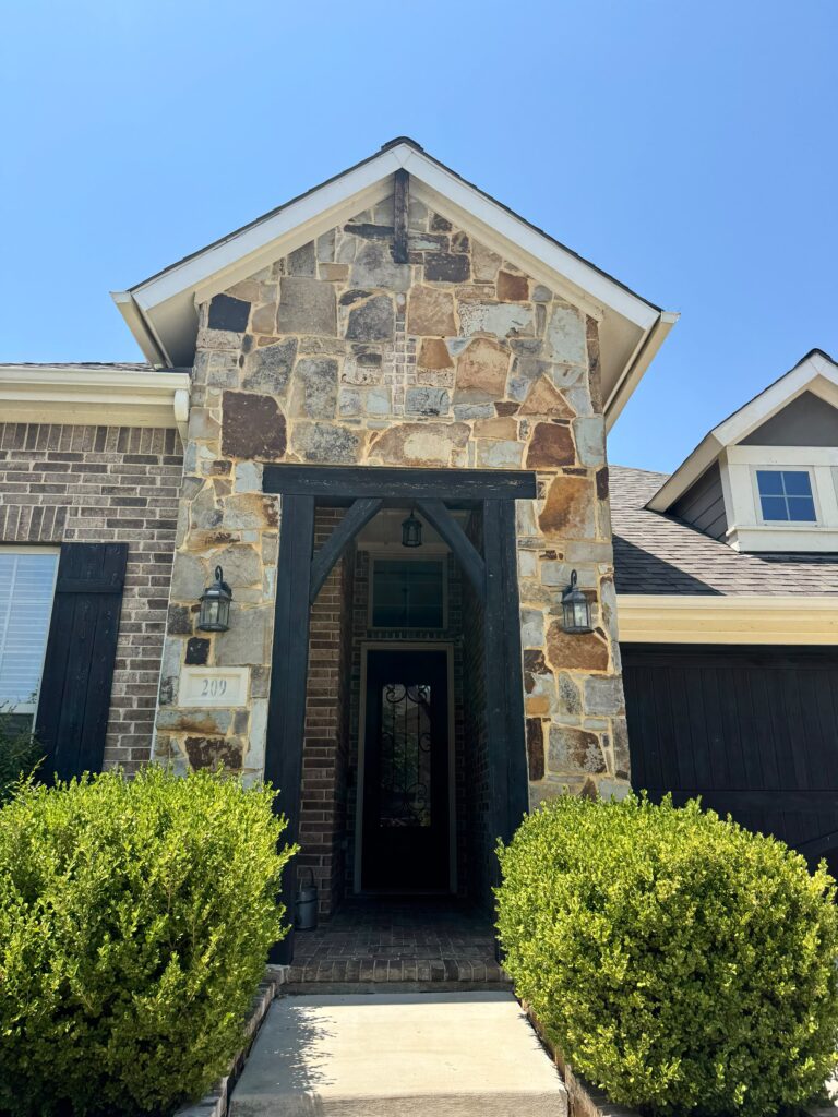 Stone entryway with dark stained wood beams painted by Beyond Painters